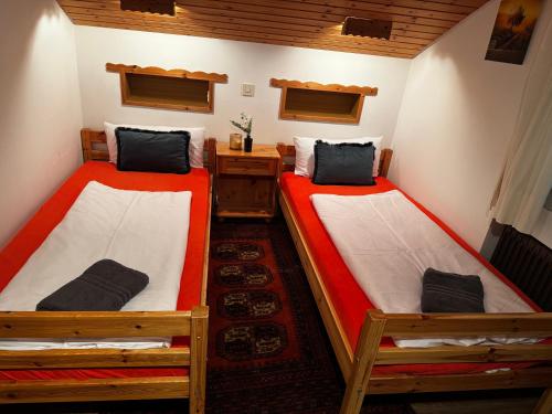 a room with two beds in a house at Am 12er in Mittelberg