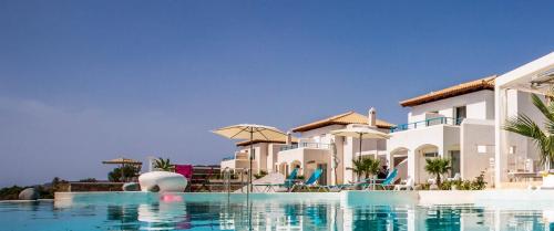 a view of a resort with a swimming pool at Kaladi Rock Avlemonas in Avlemonas