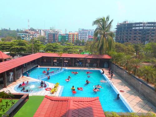 an overhead view of a swimming pool with people in it at The Cox Today Limited in Cox's Bazar