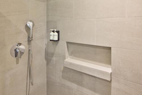 a bathroom with a shower with two bottles of soap at Go Hotels Plus Bacolod - Newly Renovated in Bacolod