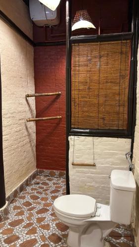 a bathroom with a toilet in a room at Sa Sa Lao in Luang Prabang