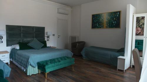 a bedroom with a bed and a desk and a chair at B&B 7 Rooms in Pisa