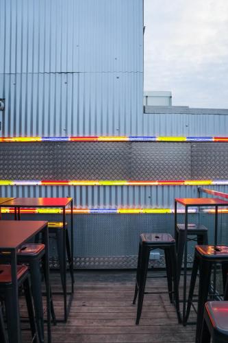 a row of tables and stools in a restaurant at JAM Brussels in Brussels