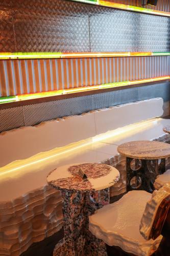 two tables and chairs in front of a bowling alley at JAM Brussels in Brussels
