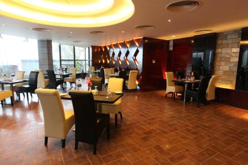 a dining room with tables and chairs in a restaurant at The Cox Today Limited in Cox's Bazar