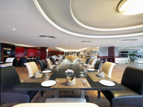 a long dining room with a long table and chairs at The Cox Today Limited in Cox's Bazar
