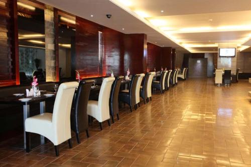 a row of tables and chairs in a restaurant at The Cox Today Limited in Cox's Bazar