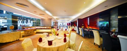 a restaurant with tables and chairs and a bar at The Cox Today Limited in Cox's Bazar