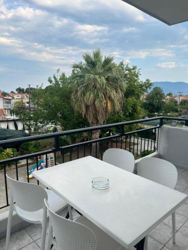 a white table and chairs on a balcony at Hotel Athina in Asprovalta