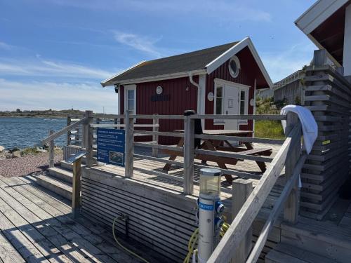 a small building on a dock next to the water at Villa Jan in Öckerö