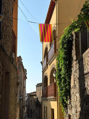 a flag hanging on the side of a building at Apartamentos Cal Ratero in Maçanet de Cabrenys