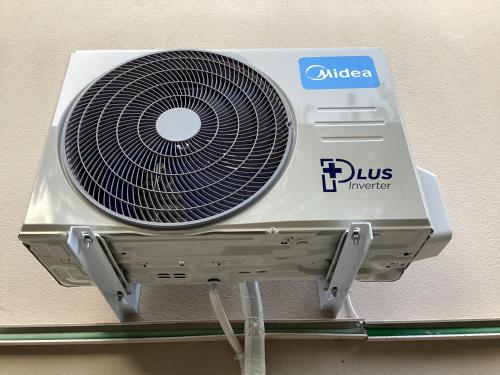 a white fan is sitting on a shelf at Heavenly place in Possidi
