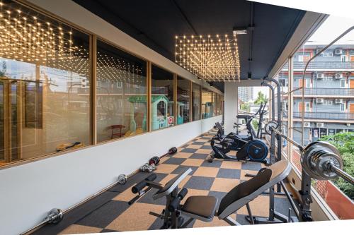 a gym with cardio equipment in a building at Metro Hotel Phahonyothin 35 in Bangkok