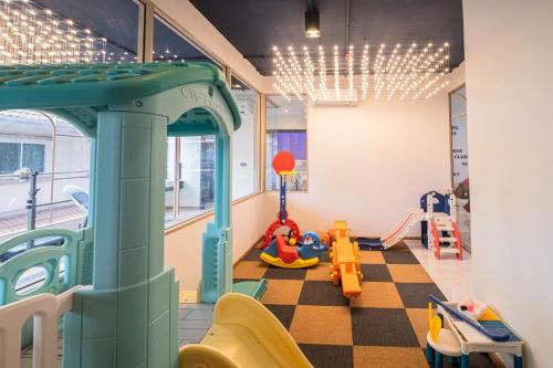 a room with a playroom with a slide and playground at Metro Hotel Phahonyothin 35 in Bangkok