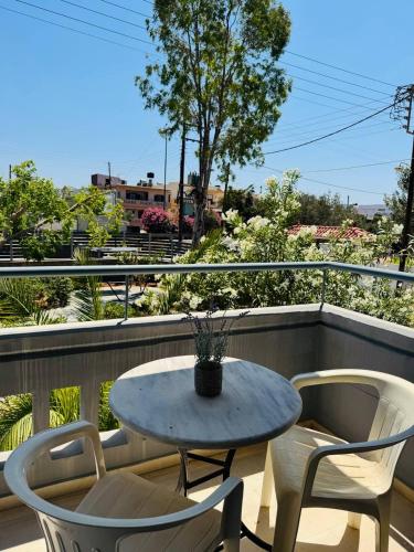 a table and two chairs on a balcony at Desire Apartments in Kato Gouves