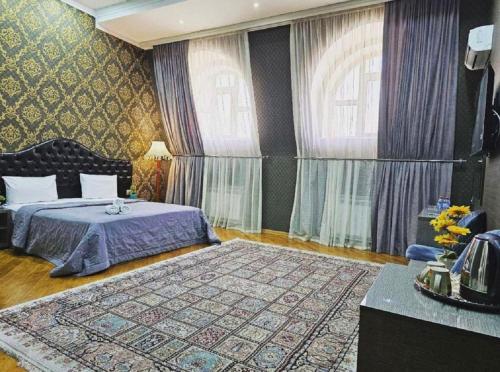 a bedroom with a bed and a large rug at Prime Boutique Hotel in Baku