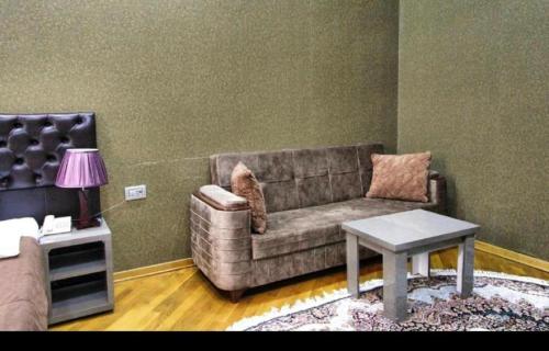 a living room with a couch and a table at Prime Boutique Hotel in Baku