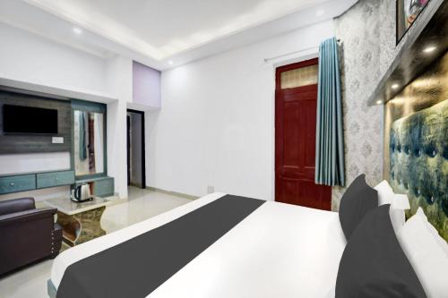 a bedroom with a bed and a couch and a tv at Hotel O Sunrise in Dānāpur