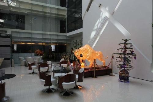 a restaurant with tables and chairs in a building at The Cox Today Limited in Cox's Bazar