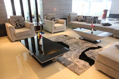 a living room with couches and a coffee table at The Cox Today Limited in Cox's Bazar