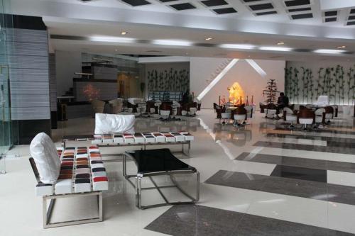 a room with chairs and a table and a fireplace at The Cox Today Limited in Cox's Bazar