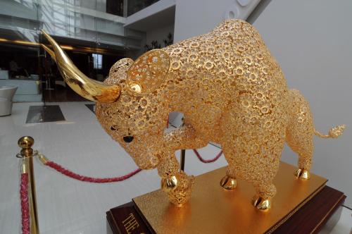 a gold bull on a table in a museum at The Cox Today Limited in Cox's Bazar