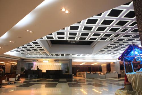 a large lobby with a white and black ceiling at The Cox Today Limited in Cox's Bazar