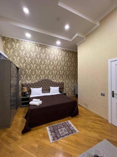 a bedroom with a large bed and a television at Prime Boutique Hotel in Baku
