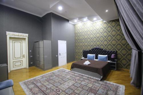 a bedroom with two beds and a door with a window at Prime Boutique Hotel in Baku