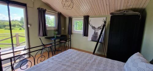 a bedroom with a bed and a window at Cosy private cottage with stunning view in Sunne