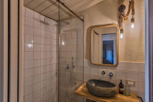 un baño con lavabo y espejo en A Casa Ruah - IsulaTravel, en Scuola