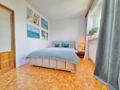 a bedroom with a bed in the middle of it at Willa Tradycja 2 in Gdańsk