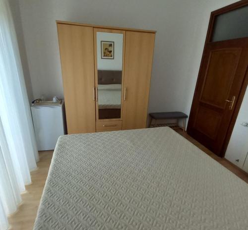 a bedroom with a bed and a wooden door at Soba Andela in Labinci