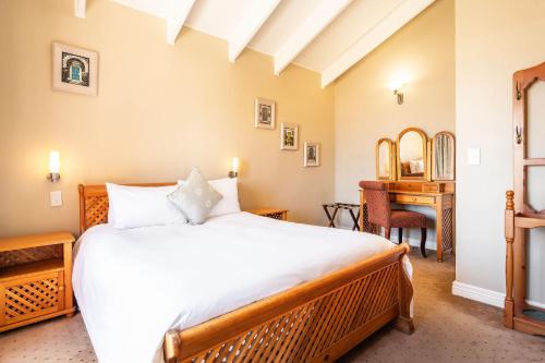 a bedroom with a large bed and a desk at Burning Shore Hotel in Langstrand