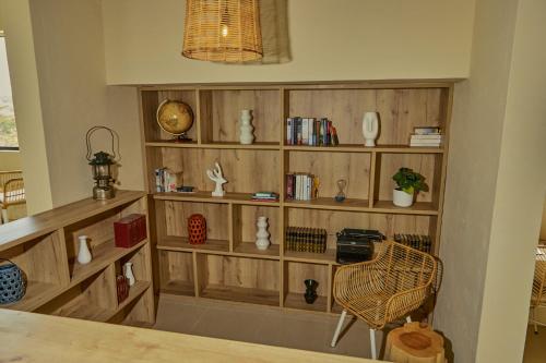 a room with wooden book shelves and a chair at La Pausa Hotelbistro in Guatapé