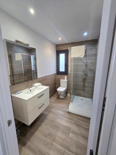 a bathroom with a toilet and a sink and a shower at SM Apartments Station in Lleida