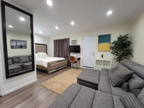 a living room with a couch and a bed at Guest suite near La Cienega Park Beverly Hills next to LACMA La Brea Tar Pits Peterson Museum and Academy Awards Museum in Los Angeles