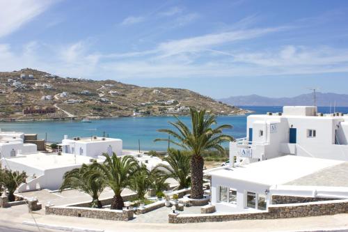 a view of a town with white buildings and palm trees at Anixi - Primavera Mykonos in Ornos