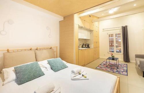 une chambre avec un lit blanc avec des serviettes dessus dans l'établissement GuestReady - Modern Studio 1min Charonne Metro, à Paris