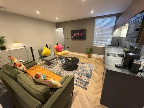 a living room with a couch and a table at Short Walk to CoOp Live and Etihad Stadium in Manchester