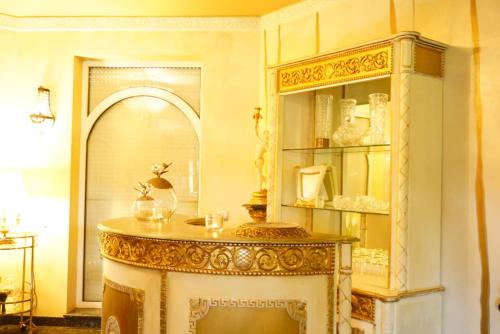 a room with a table and a shelf with items at Willa Antyki24 nad Białym Jeziorem Kameralny Azyl in Sztum