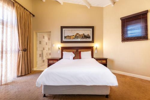 a bedroom with a white bed and a window at Burning Shore Hotel in Langstrand