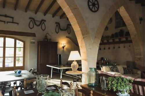 a living room with an archway with a table and chairs at Finca Can Estades in Calvia Town