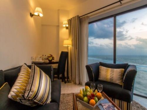 a living room with a view of the ocean at The Ocean Colombo in Colombo