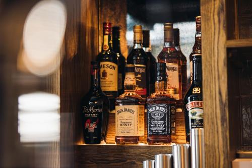 a bunch of bottles of alcohol on a shelf at Gaskell Arms in Much Wenlock