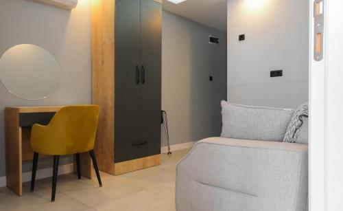 a bedroom with a bed and a chair and a cabinet at Likya 202 in Demre