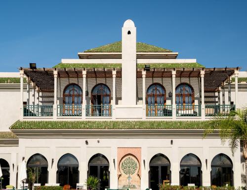a building with a tower on top of it at Pickalbatros Hôtel Du Golf - Adults Friendly 16 Years Plus- All-Inclusive in Marrakech