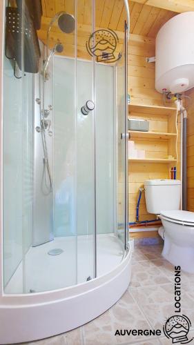 a shower stall in a bathroom with a toilet at Chalet Hestia in Murol