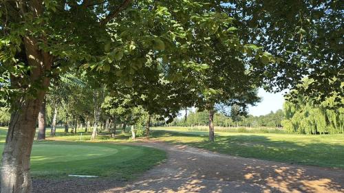 a dirt road in a park with trees and grass at Golfing & Family Breaks in Luxury Lodge in Tydd Saint Giles