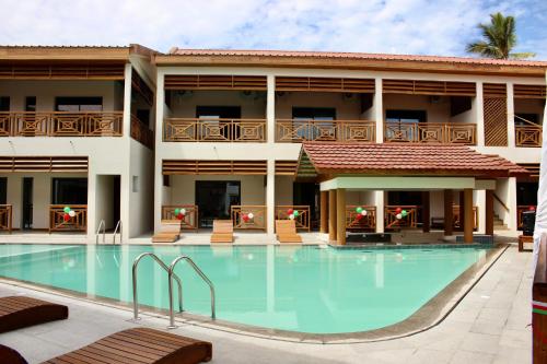 a swimming pool in front of a hotel at ANNEXE VEZO BEACH Hotel in Morondava